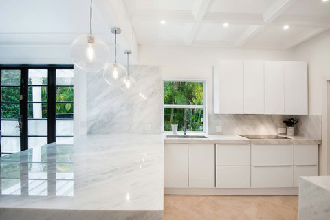 Entertaining Perfect Private Chef Dining Kitchen with Brazilian marble waterfall kitchen bar. Stainless build-in custom appliances with state of art induction cooking and wine fridge, soda stream, and nespresso cappucino maker.  