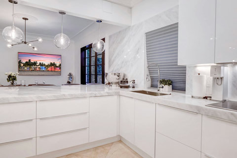 Entertaining Perfect Private Chef Dining Kitchen with Brazilian marble waterfall kitchen bar. Stainless build-in custom appliances with state of art induction cooking and wine fridge, soda stream, and nespresso cappucino maker.  