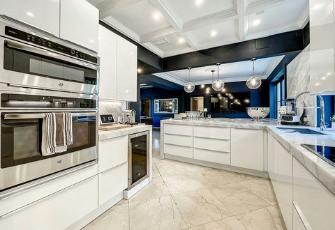 Entertaining Perfect Private Chef Dining Kitchen with Brazilian marble waterfall kitchen bar. Stainless build-in custom appliances with state of art induction cooking and wine fridge, soda stream, and nespresso cappucino maker.  