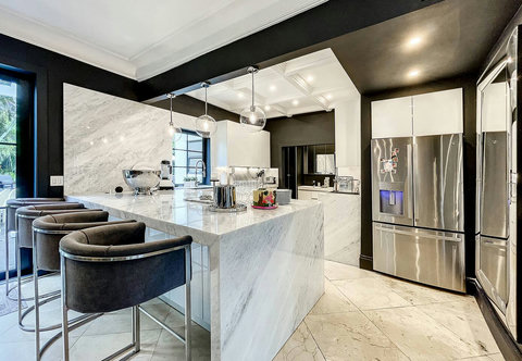 Entertaining Dining room and Brazilian marble waterfall kitchen bar. Stainless build-in custom appliances with state of art induction cooking and wine fridge, soda stream, and nespresso cappucino maker.  