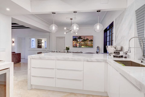 Entertaining Perfect Private Chef Dining Kitchen with Brazilian marble waterfall kitchen bar. Stainless build-in custom appliances with state of art induction cooking and wine fridge, soda stream, and nespresso cappucino maker.  