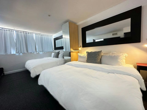 Bedroom with 2 King Beds and closet and minibar. All Bedrooms come with comfortable down comforters and down pillows.