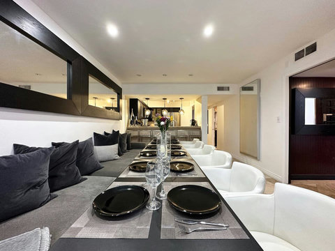 Welcome to Entertaining Modern Living! Gather in this spacious Dining & Bar Lounge with a long table for larger groups. Enjoy the 70-inch 4K Smart TV and step outside to the outdoor SPA patio. Perfect for memorable moments with family & friends!
