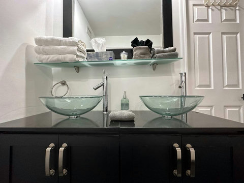 Modern bathroom with a combination shower - bathtub, and dual sinks.
