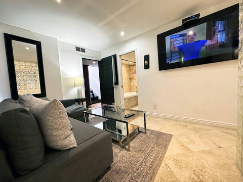 Unwind in our welcoming living room, featuring a comfortable sofa group and a state-of-the-art 50-inch Smart TV.