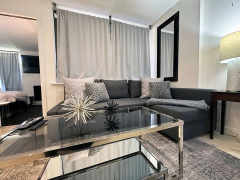 Unwind in our welcoming living room, featuring a comfortable sofa group and a state-of-the-art 50-inch Smart TV.