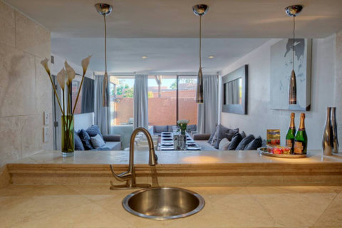 Welcome to Entertaining Modern Living! Gather in this spacious Dining & Bar Lounge with a long table for larger groups. Enjoy the 70-inch 4K Smart TV and step outside to the outdoor SPA patio. Perfect for memorable moments with family & friends!

