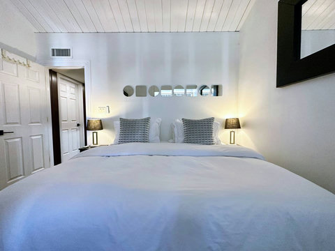 Luxurious Master Bedroom with Golf Course Views, Private Balcony, and 60-inch Smart TV. Can be set up with 1 King or 2 Twin Beds. All Bedrooms come with comfortable down comforters and down pillows.