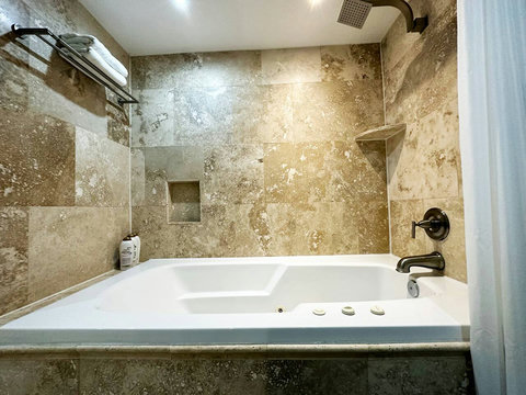 Unwind in style with both a shower and a jacuzzi tub in this elegant bathroom.