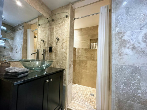 Refresh in style with this modern bathroom featuring a dual shower.
