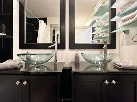 Step into this contemporary bathroom with dual sinks and a shower and bathtub combination. 
