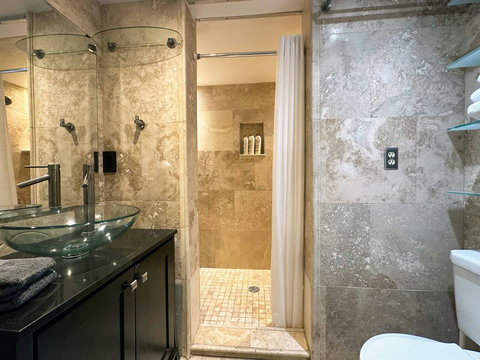 Refresh in style with this modern bathroom featuring a dual shower.
