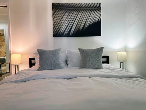 Bedroom with 1 King or 2 Twin Beds, 42-inch Smart TV, and closet. All Bedrooms come with comfortable down comforters and down pillows.