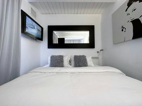 Bedroom with 1 King or 2 Twin Beds with a Private Patio with Morning Sun. All Bedrooms come with comfortable down comforters and down pillows. 