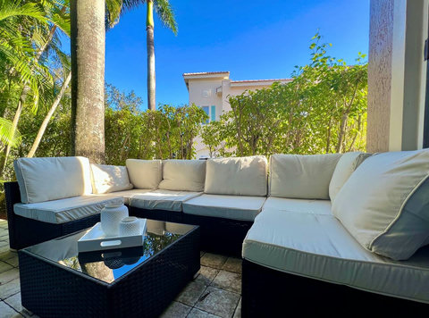 Embrace nature's embrace! Our chic home offers an inviting outdoor living room, where relaxation and natural beauty unite. 