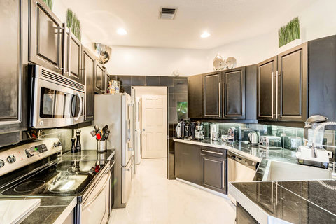 Indulge in our home's fully equipped kitchen, boasting top-of-the-line stainless steel appliances for a stylish cooking experience. 