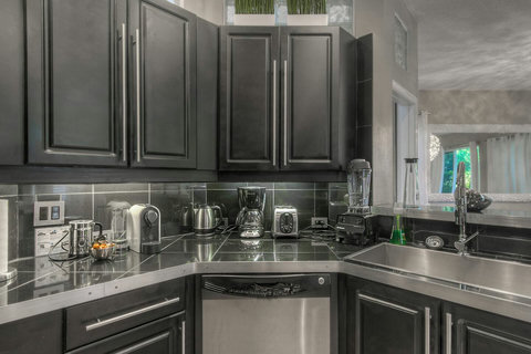 Indulge in our home's fully equipped kitchen, boasting top-of-the-line stainless steel appliances for a stylish cooking experience. 