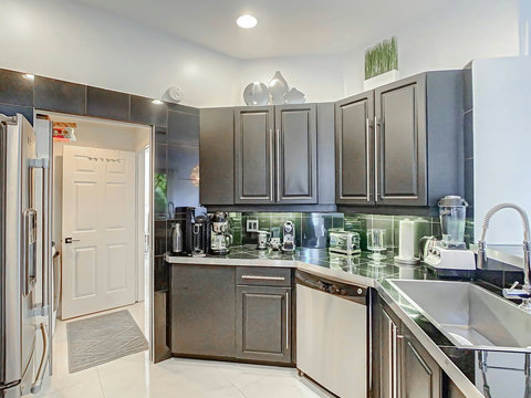 Indulge in our home's fully equipped kitchen, boasting top-of-the-line stainless steel appliances for a stylish cooking experience. 