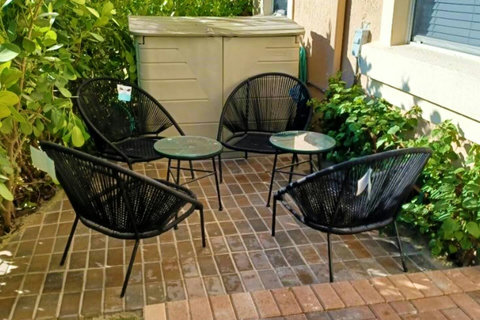 Sun-kissed mornings! Experience our front patio, where the morning sun sets the stage for a cozy breakfast retreat.