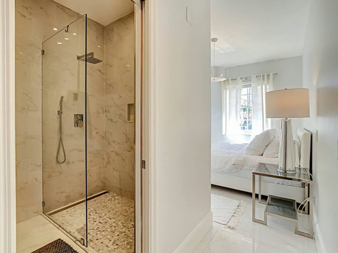 Indulge in comfort! Experience our elegant spacious bathroom with a modern shower, inviting you to unwind and refresh.