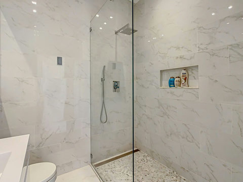 Indulge in comfort! Experience our elegant  spacious bathroom with a modern shower, inviting you to unwind and refresh.