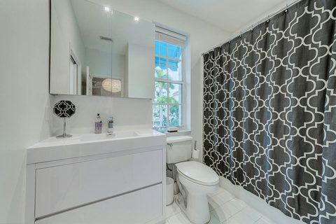 Experience our elegant bathroom, with the luxury of both a bathtub and a serene shower space.