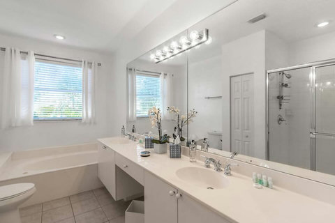 Experience our elegant bathroom, with the luxury of both a bathtub and a serene shower space.