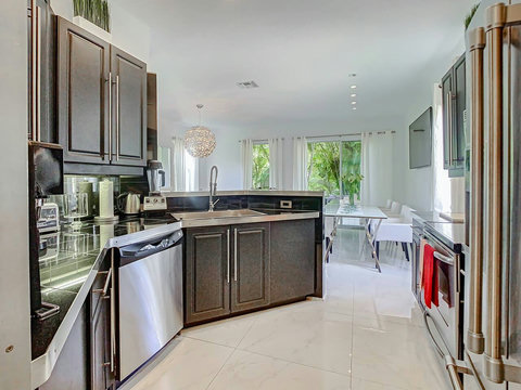 Indulge in our home's fully equipped kitchen, boasting top-of-the-line stainless steel appliances for a stylish cooking experience. 