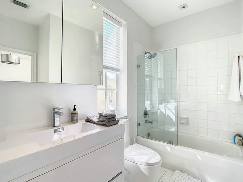 Experience our elegant bathroom, with the luxury of both a bathtub and a serene shower space.