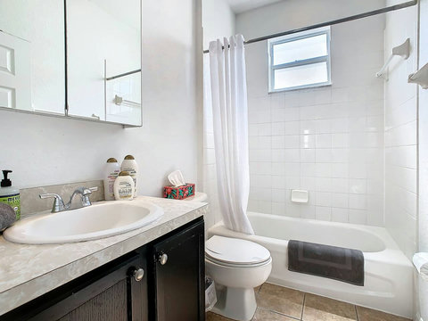 Pamper yourself in style! Enjoy a spa-like experience in this bathroom with shower, tub, and all the necessary bath essentials.