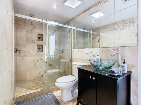 Pamper yourself in style! Unwind in this chic bathroom with a refreshing shower, offering a tranquil escape.
