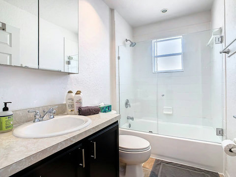 Pamper yourself in style! Enjoy a spa-like experience in this bathroom with shower, tub, and all the necessary bath essentials.