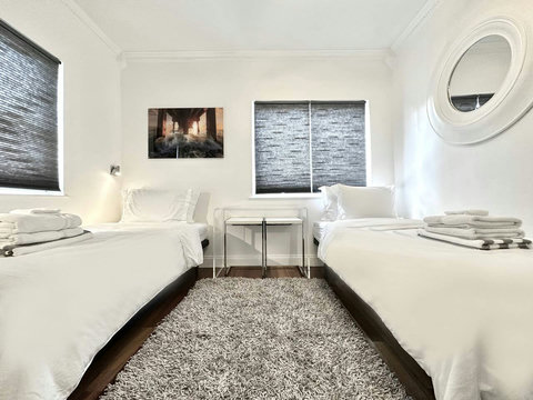 Optional 7th bedroom (otherwise will normally be set up as a lounge room).
An elegantly compact designer bedroom boasting a 2 luxurious day beds, and closet, multiple windows which create a bright, open, and sophisticated atmosphere.