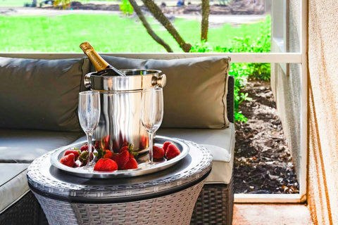 Immerse in Luxury - Relax in our stylish Outdoor Livingroom Patio with a wall-mounted TV, offering stunning views of the PGA Clubhouse and Learning Center.