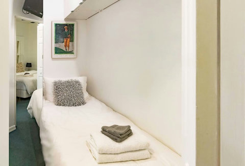 The Bedroom Den features 1 Single Bed, 24-inch Smart TV, and closet.
