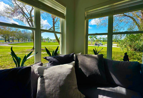 View from Golf Villa living room: overlooking PGA Golf Club at PGA Village's Driving Range, Pitch-n-Putt course, Short Game area, and Clubhouse. 