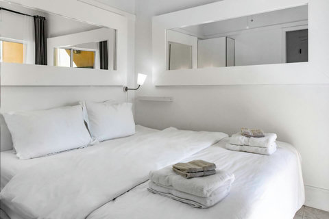 Bedroom with 1 King Bed or 2 Twin Beds, 24-inch Smart TV, closet, and overlooking the patio with views over the golf course.