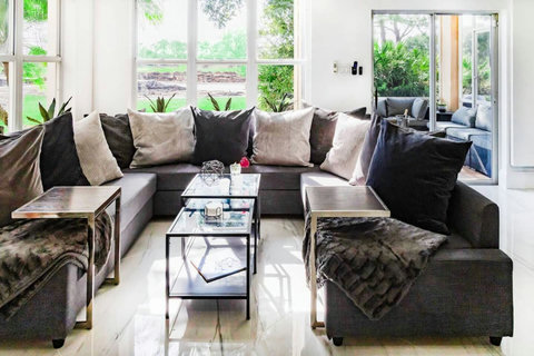 Open floor plan with plenty of seating inside and outside. Living room and patio overlooking the pitch and putt.
