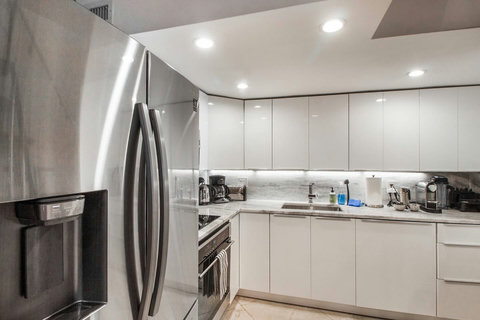 Fully equipped kitchen with stainless steel appliances, state-of-the-art induction cook-top, convection health cooking oven, built-in oven, Brazilian marble counter top, Nespresso cappuccino maker, Keurig coffee maker, brew coffee, and condiments. 