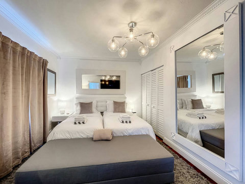 Master Bedroom en-suite with 2 King Size beds and 70 inch smart TVs.