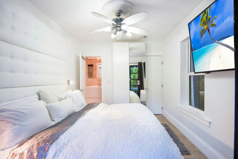 An elegantly compact designer bedroom boasting a luxurious KING-size beds (or 2 twin beds upon request), and closet, window and french doors leading out to balcony walkway which create a bright, open, and sophisticated atmosphere.