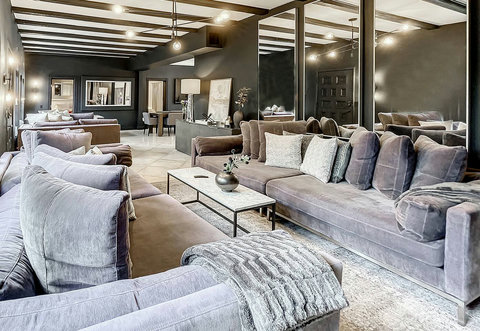 Living room with oversized custom-made designer sofas made in California with designer pillows and an 86-inch smart TV for the movie theater entertainment experience. Netflix and Amazon movies are included. 