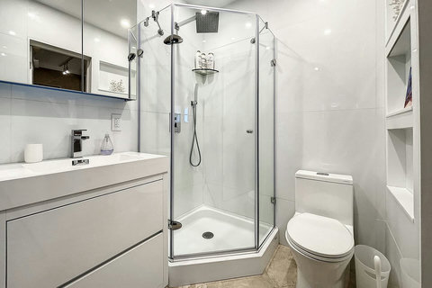 Bathroom, with toilet, sink and shower.