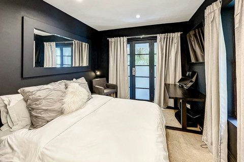 An elegantly compact designer bedroom boasting a luxurious KING-size beds (or 2 twin beds upon request), and closet, window and french doors leading out to balcony walkway which create a bright, open, and sophisticated atmosphere.