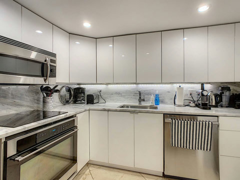 Fully equipped kitchen with stainless steel appliances, state-of-the-art induction cook-top, convection health cooking oven, built-in oven, Brazilian marble counter top, Nespresso cappuccino maker, Keurig coffee maker, brew coffee, and condiments. 