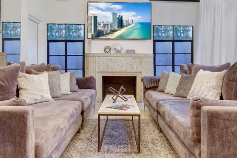 Entertaining open floor plan with oversized sofas and two 86 inch Smart TVs  