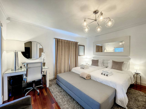 Master Bedroom en-suite with 2 King Size beds and 70 inch smart TVs.
