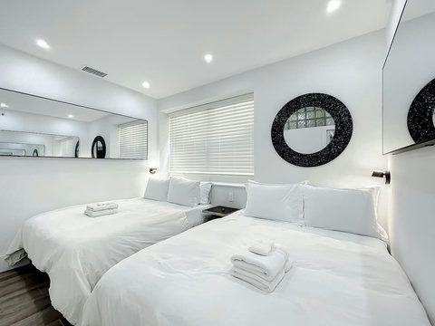 Rest in comfort! Discover a bedroom with memory foam mattresses, cozy dimmer lighting, USB chargers, Designer Mirrors, and Art Deco glass design.