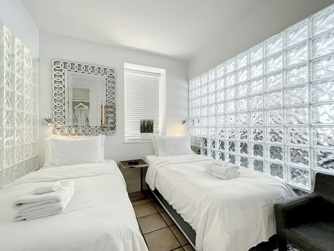 Rest in comfort! Discover a bedroom with memory foam mattresses, cozy dimmer lighting, USB chargers, Designer Mirrors, and Art Deco glass design.
