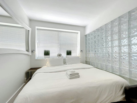 Rest in comfort! Discover a bedroom with memory foam mattresses, cozy dimmer lighting, USB chargers, Designer Mirrors, and Art Deco glass design.
